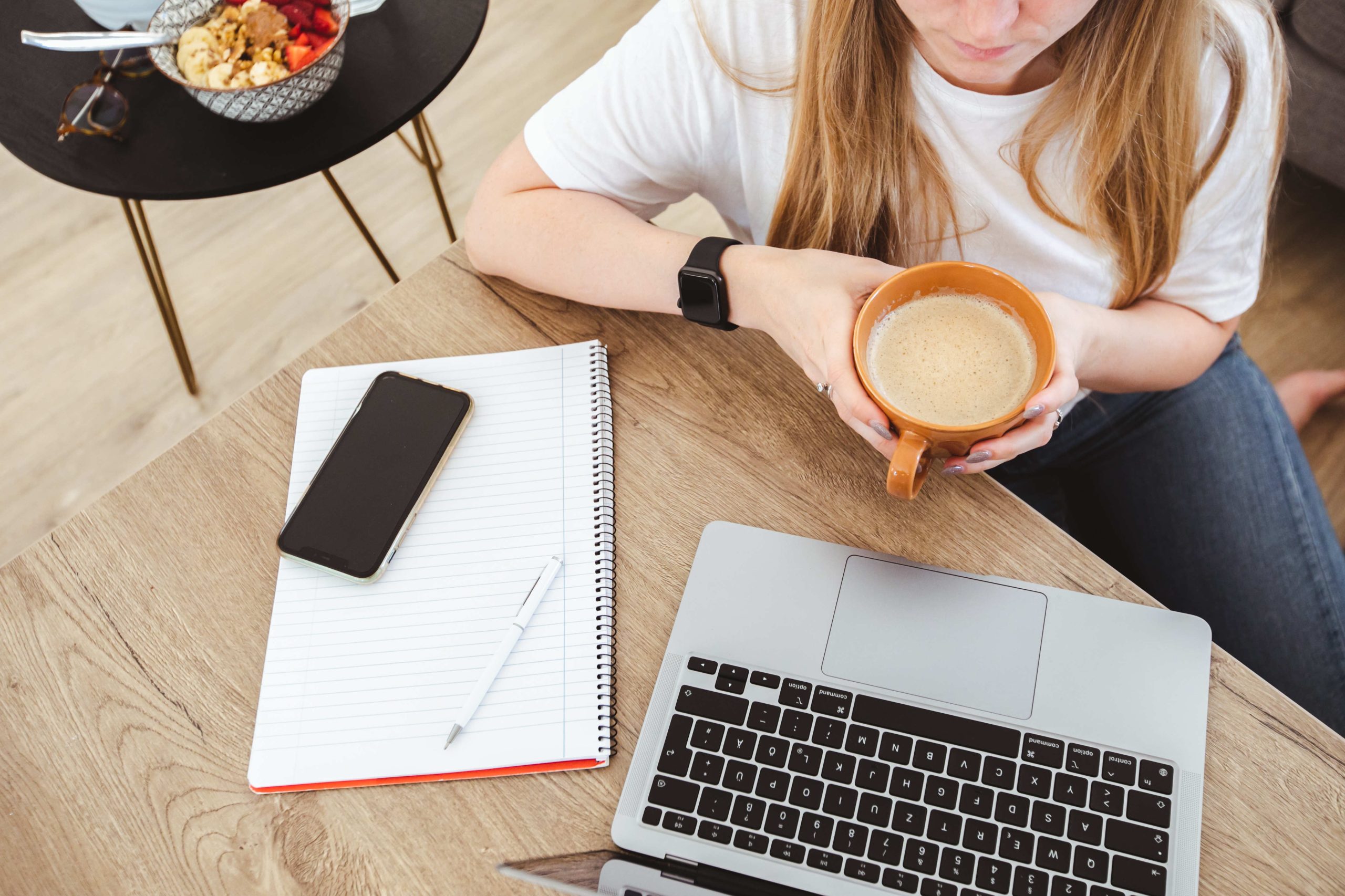 Woman working from home with coffee in her hand