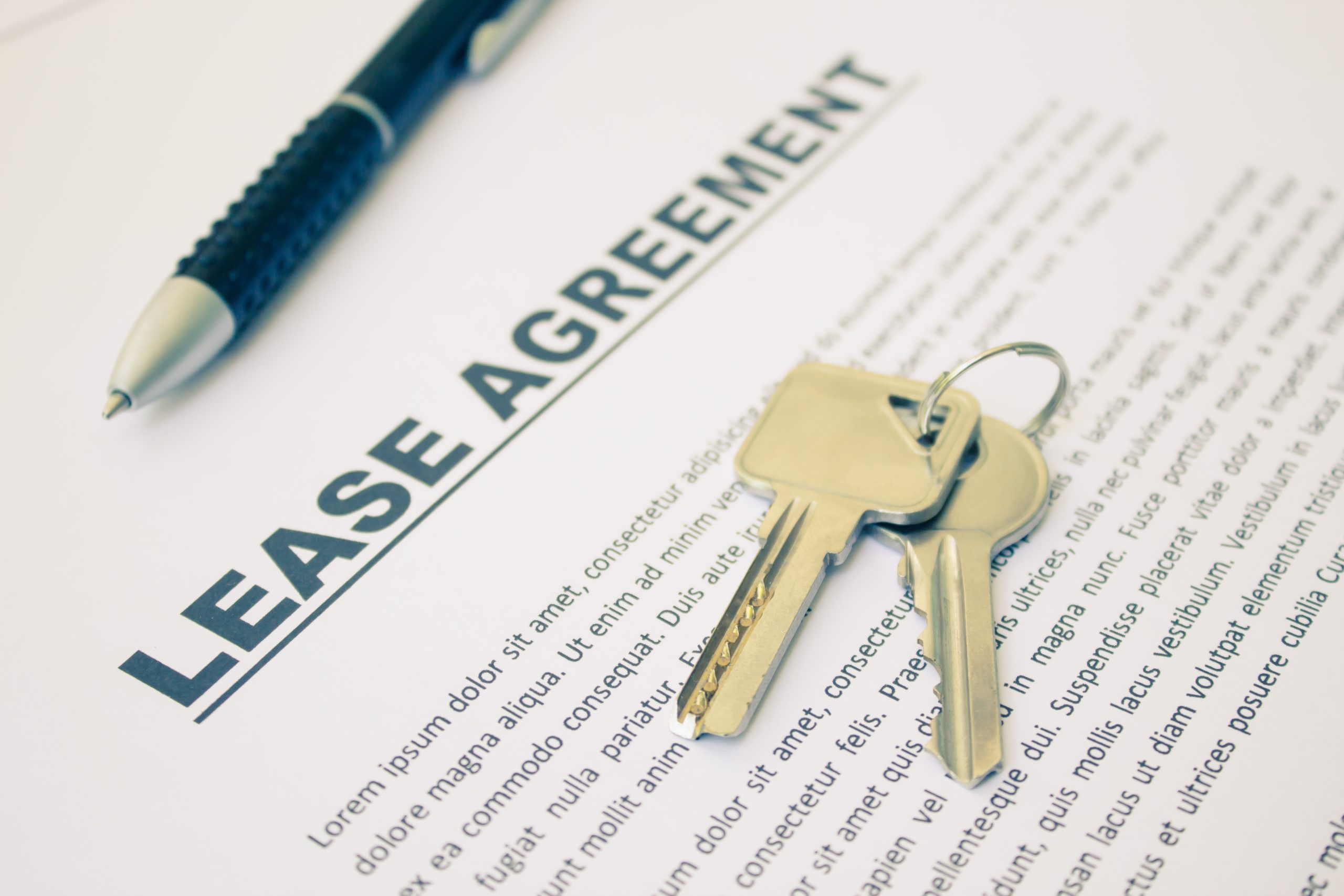 Office lease agreement with keys and pen