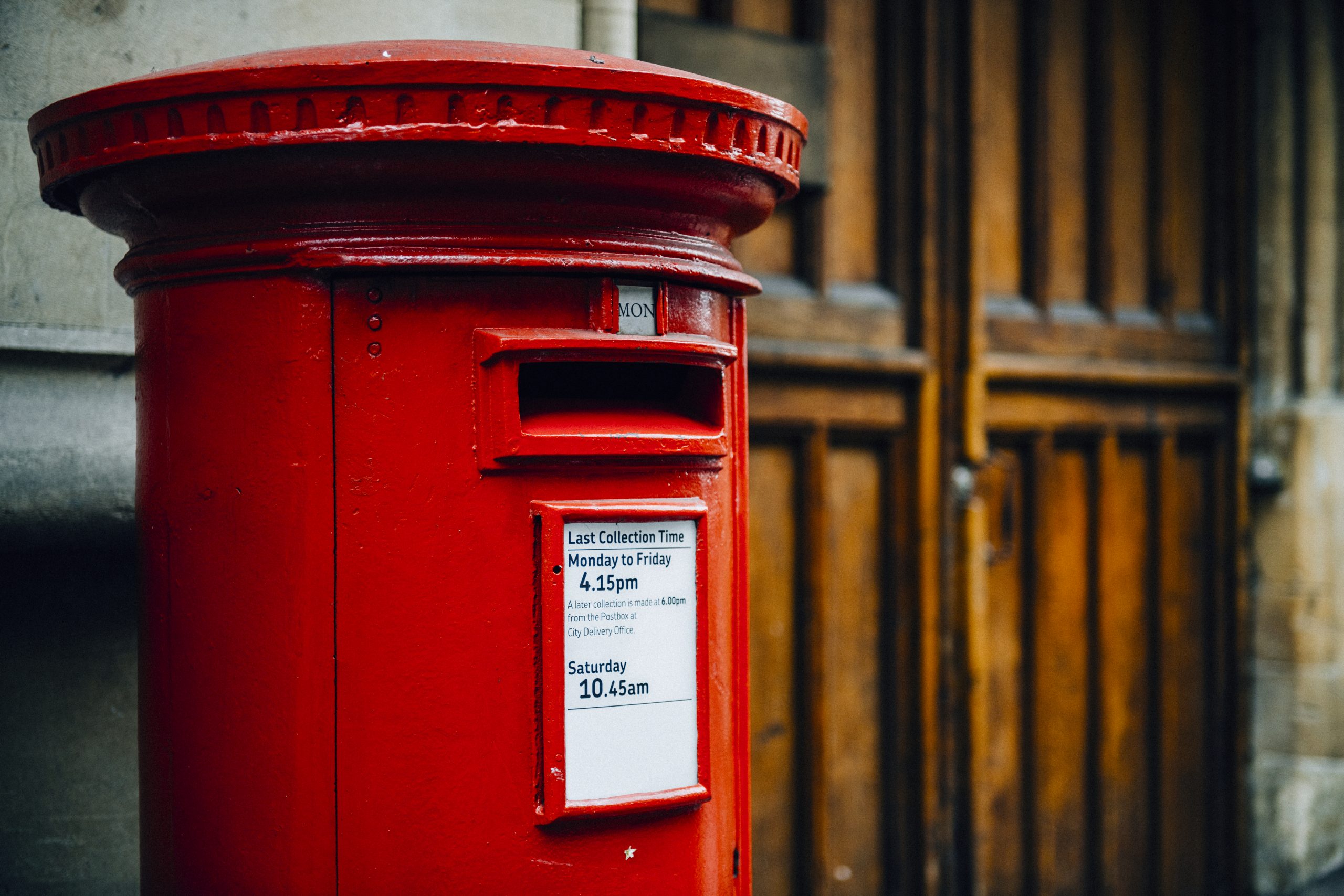 Iconic red British mailbox in a city