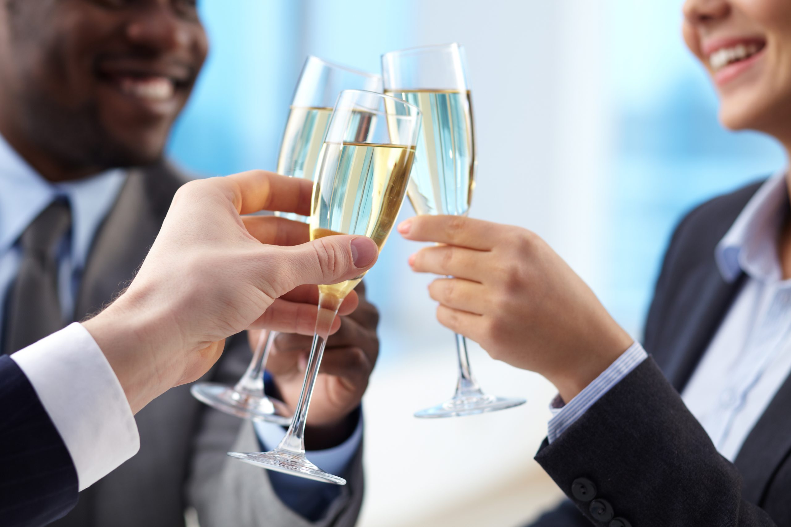 Business owners celebrating launch of startup business with champagne